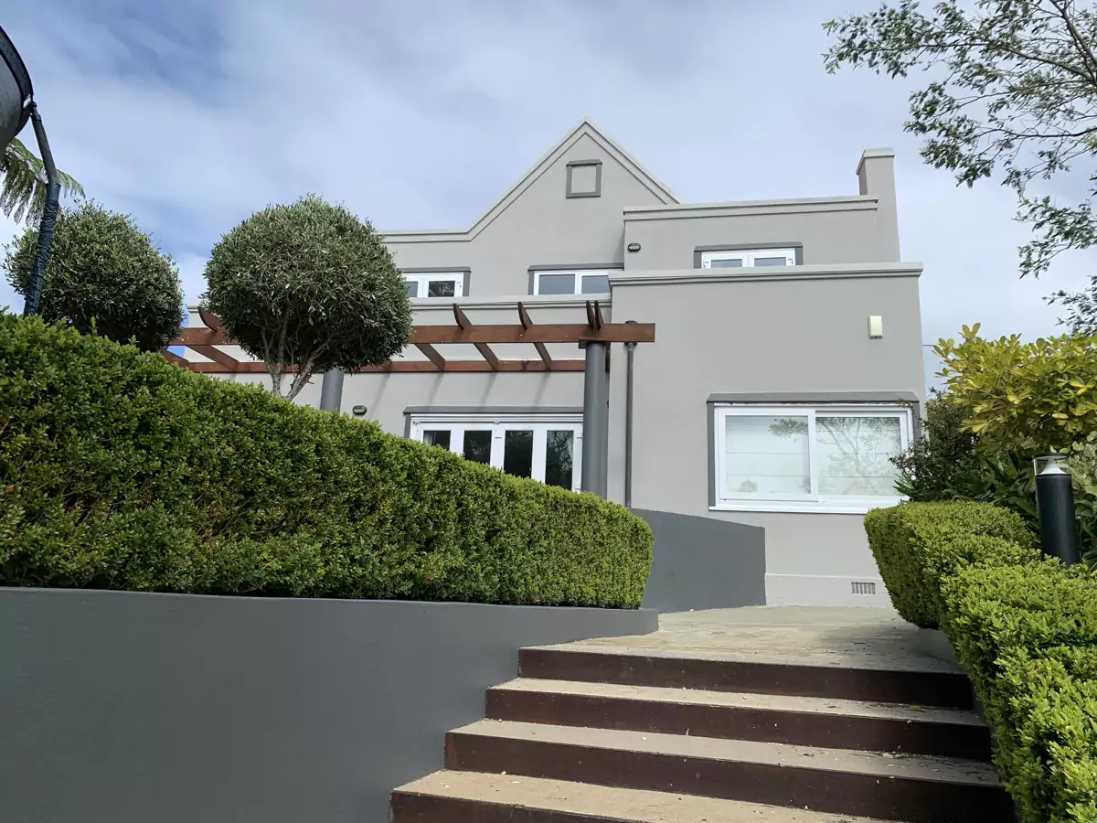 Freshly coated character home surrounded by established gardens